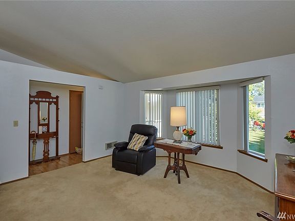 Another View Of Living Area With Light Filled Windows Looking Out To Front Yard