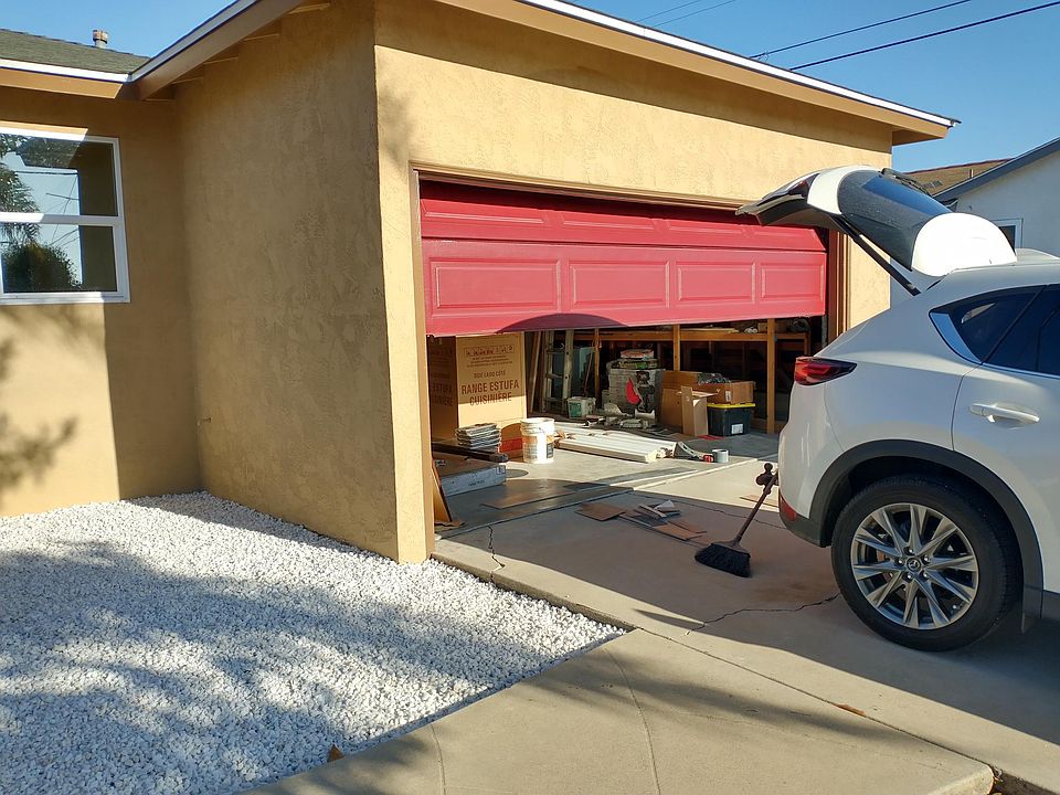2.5-car garage with storage shelves along the length of one wall and extra room before entering the house for laundry and more storage.