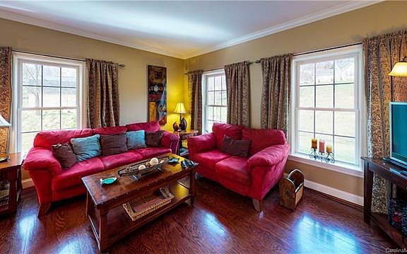 Sunny family room with hardwood flooring and crown molding