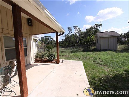 back covered patio with view of pump house