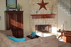 Warm living room with 2 story stone fireplace