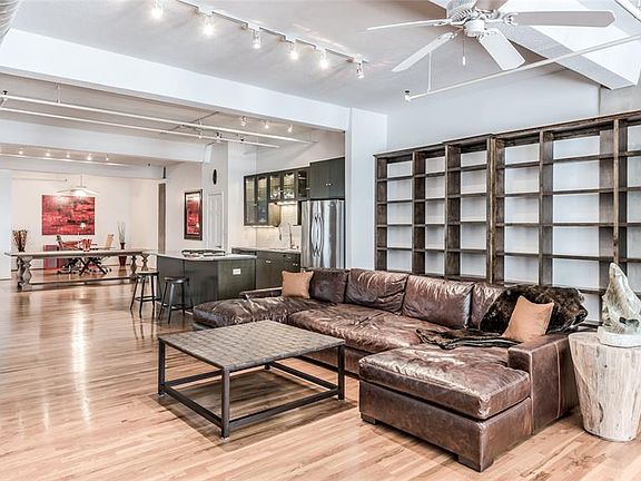 Living Room features wall of built-in bookcases on both sides of room. This huge open space allows for you to arrange furniture and create vignettes that fit your particular lifestyle. There are no design rules when it comes to open loft living!
