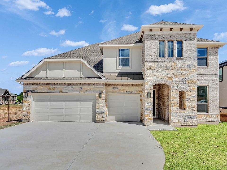 Exquisite two-story residence in Dartmouth at Hawkes Landing, featuring elegant brick and stone faca