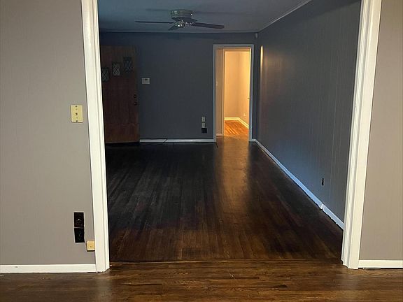 Office/additional living room facing towards bedrooms. One bedroom has hardwood floors. Second bedroom has new carpet.