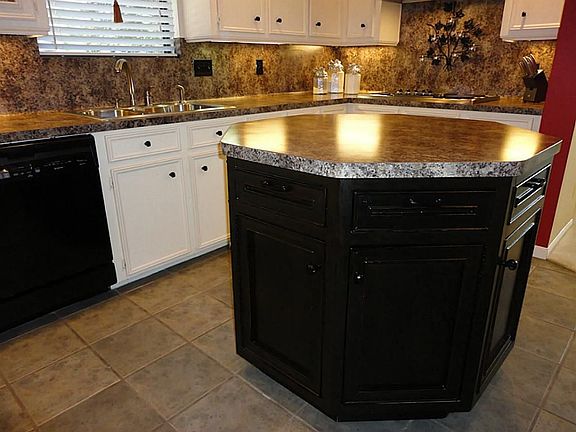 Octagonal shaped center island - custom built and designed - provides additional storage and is move