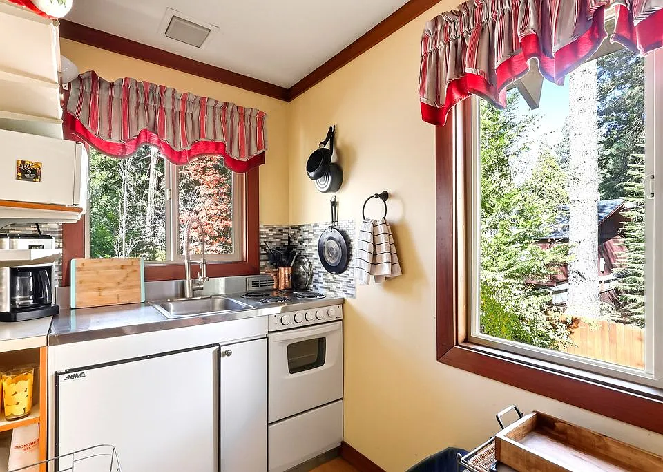 Kitchen with stove, refrigerator, micro dishes, glasses and cookware, 4 top burners. Extra refrigerator space near garage in hallway.