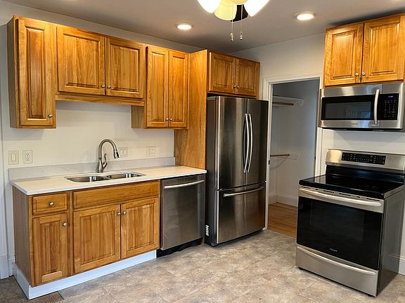 Kitchen with stainless steel appliances and large closet