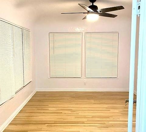 Den with linen closet and lots of windows