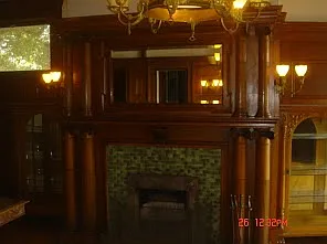 beautiful fireplace hand carved mantel inset with tile and bronze cover
