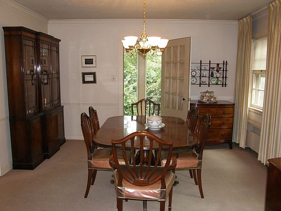 The dining room features carp over hrd wd flrs & a door that leads to patio 