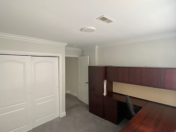 Third bedroom/ Office. Convert to bedroom or facilitate work and business needs with wrap around desk with ample space, bulletin board, desk light and dry erase board