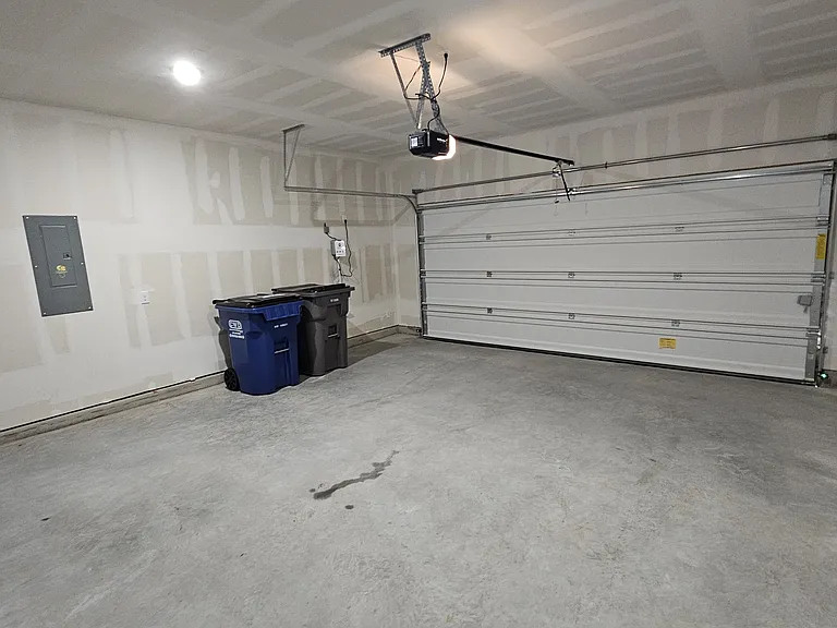 Spacious two-car garage with a clean finish and dedicated extra storage space for all your organizational needs