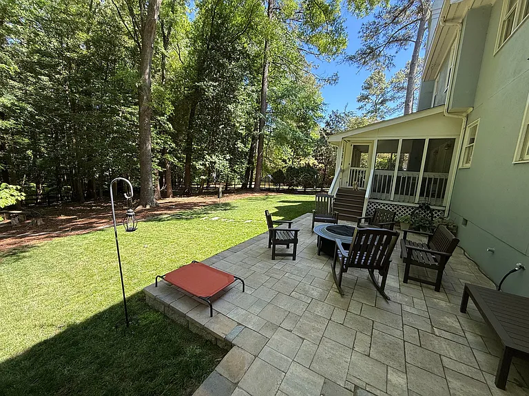 New stone patio & backyard (screened-in porch steps/entrance in background)