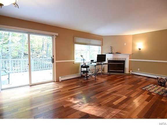 Spacious living room and dining room lead to private deck.  Wood burning fireplace in living room.