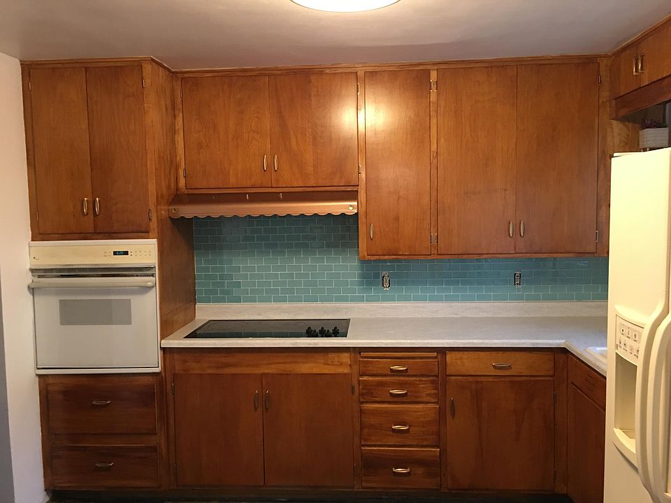 Refurbished original cabinetry. New glass backsplash. New sink, faucet and disposal.