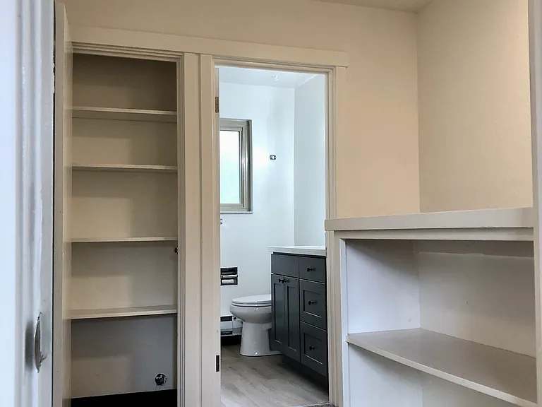 view of hall storage and full bath