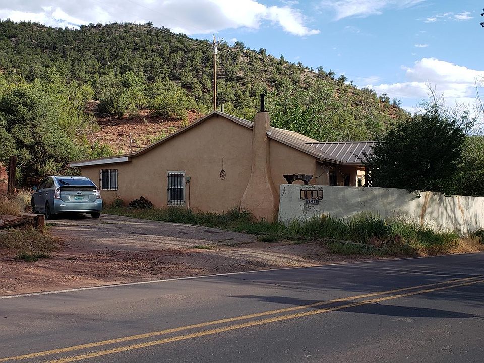 Home nestled between three hillsides to give more privacy. Paved off-street parking