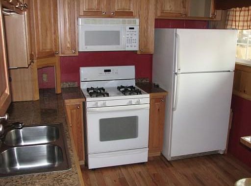 Kitchen has granite & hardwoods