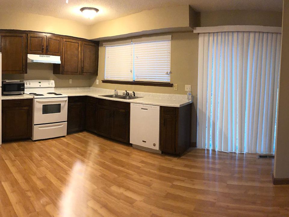 Kitchen has ceiling fan, new fridge, new stove, new hood and new dishwasher. Sliding doors look out to back patio.