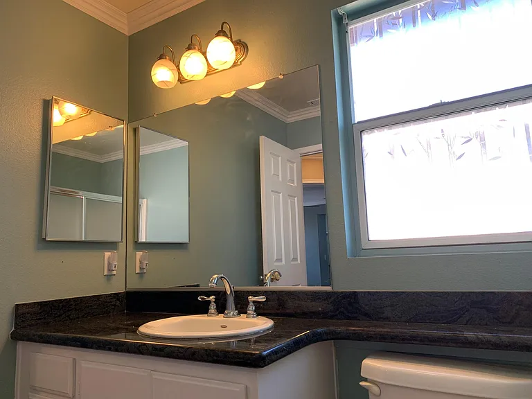 Shared bathroom on 2nd floor with hardwood floor and granite countertop.