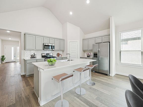 Kitchen in the Claret home plan by Trophy Signature Homes - REPRESENTATIVE PHOTO