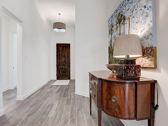 Step inside to discover beautiful wood-look tile floors, a thirteen foot tray ceiling with elegant lighting, and soft neutral paint throughout the foyer.