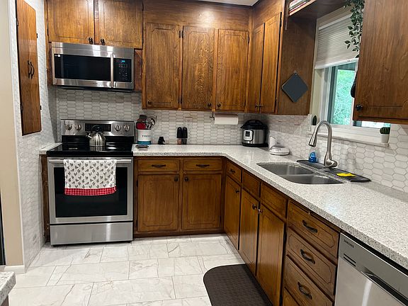 Well-equipped kitchen with modern appliances, full cookware, and a spacious U-shaped layout designed for easy meal prep during extended stays.