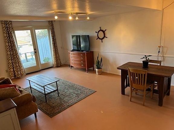 Entrance with dining table and TV