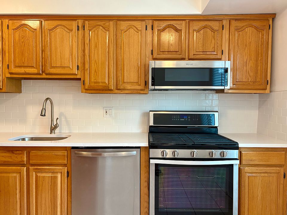 Kitchen | Refreshed w/ new countertops and stainless steel sink + appliances.