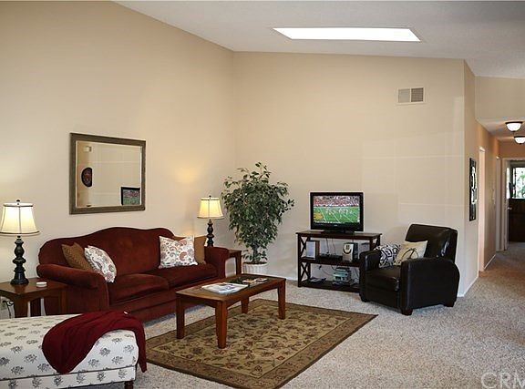 Open Floor plan - Living room opens onto a large covered veranda and also features a vaulted ceiling