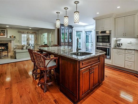 A newly updated state-of-the-art kitchen is a gourmet's delight featuring a huge center island.