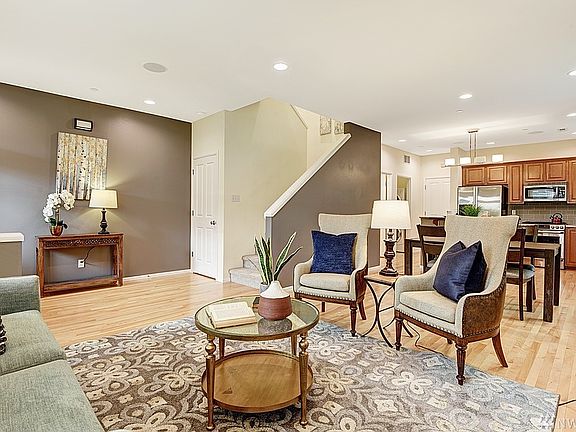 Open, great room design with colored accent walls, hardwood floors and cozy fireplace.