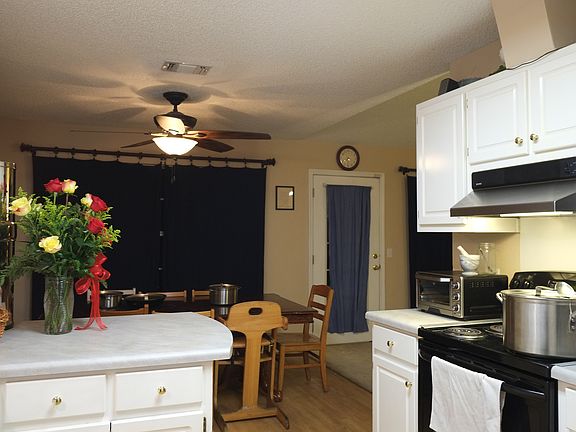 Kitchen with dining area and breakfast bar.