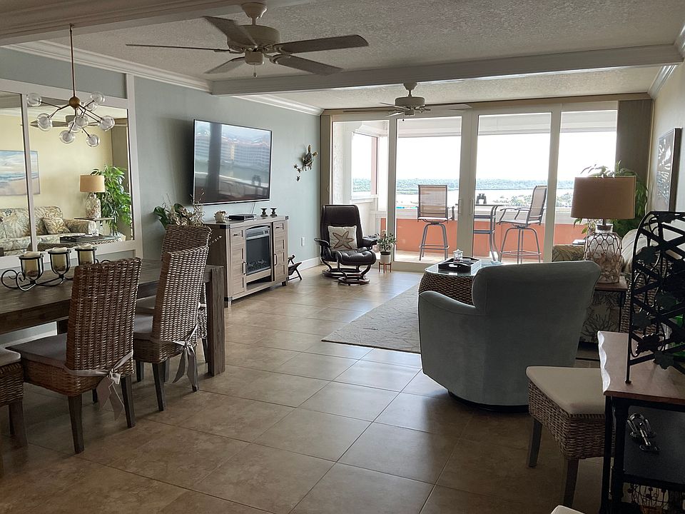 This beamed ceiling living room has a coastal feel with MAGNIFICENT water views.