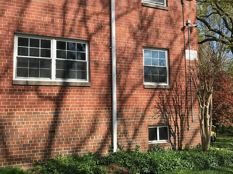 View of living room windows from parking space