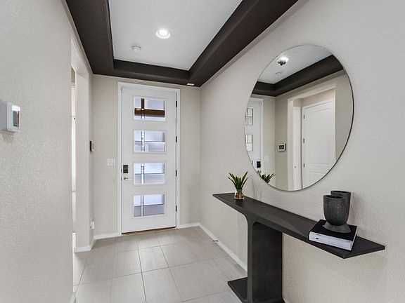 The Tifton Walk home greets you with a foyer and modern front door.