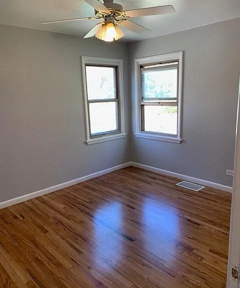 Master bedroom with closet and ceiling fan/light
