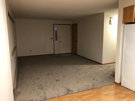 Front door in Living room with coat closet