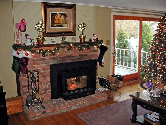 FIREPLACE WITH WOOD BURNING INSERT WITH SLIDERS TO TREX DECK 