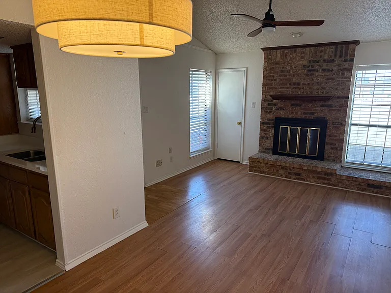Brick fireplace and mantel. Light and bright space with windows. Clean and ready for move-in.