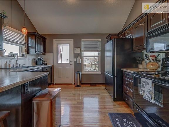 Open kitchen walks out to an oversized deck overlooking the neighborhood pool.