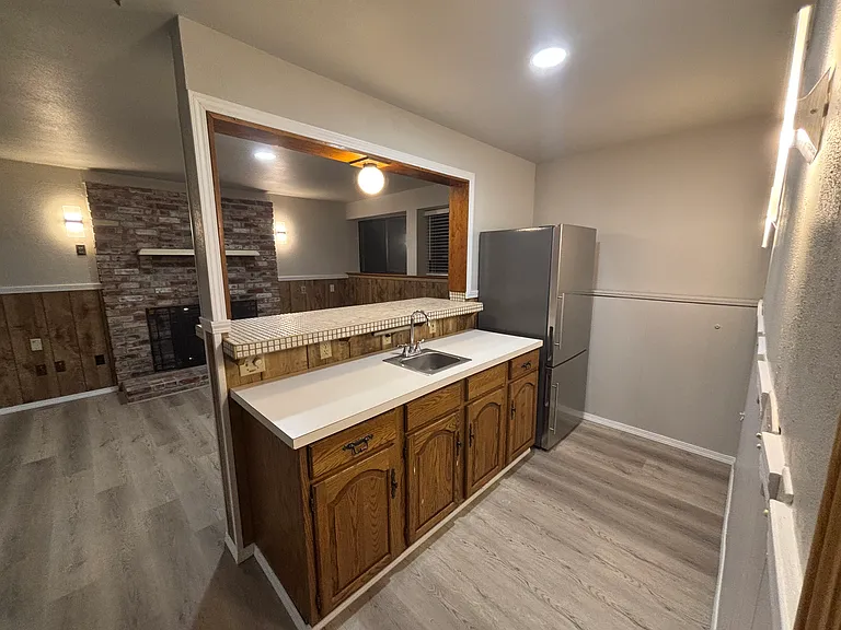View of the downstairs wet bar that includes a brand new refrigerator
