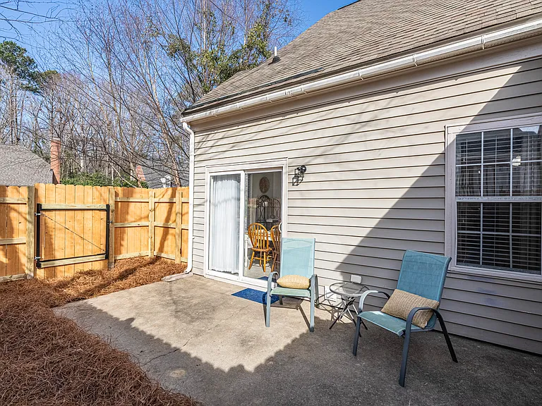 Exterior patio area with new fence and gate to allow access to side yard.