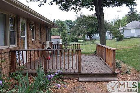 Back deck.  Five entrances into this lovely brick ranch.