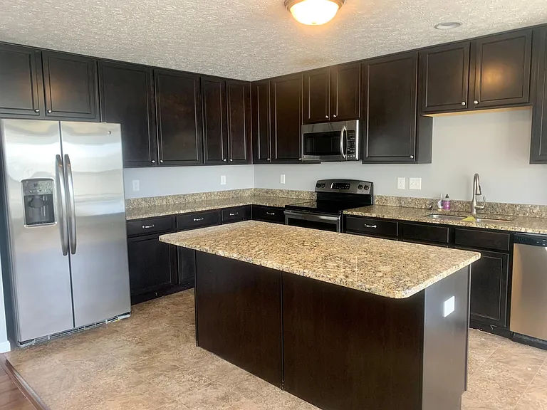 Kitchen- granite counter tops, stainless steel appliances, 42 inch cabinets