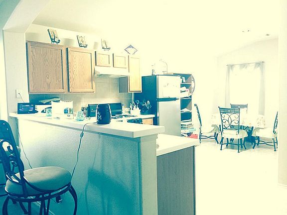 Breakfast bar/area with an open kitchen that is overlooking to your living area