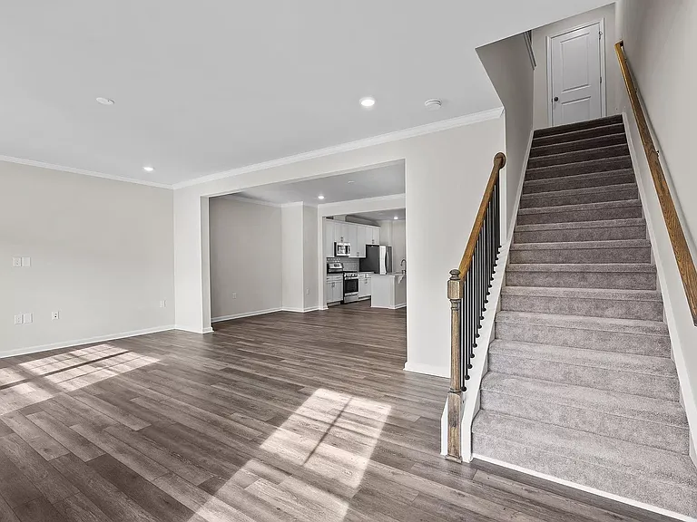 living room and stairs to third floor to Master bed, and 2 other bedrooms