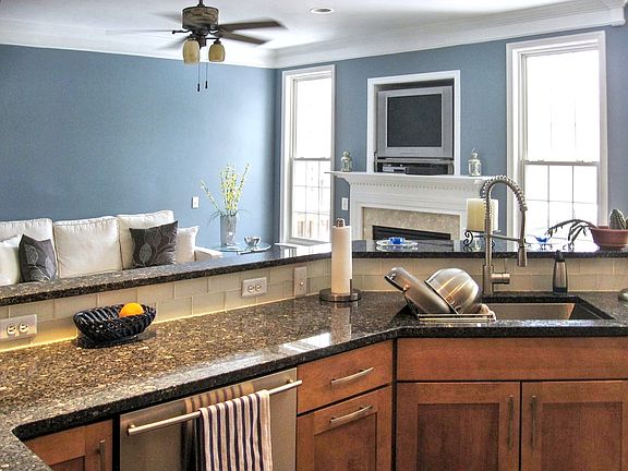 Updated kitchen with granite, stainless steel appliances and gray hardwood floors throughout main level.