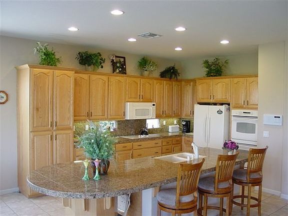 Kitchen with oak cabinets, granite counters, tile floors