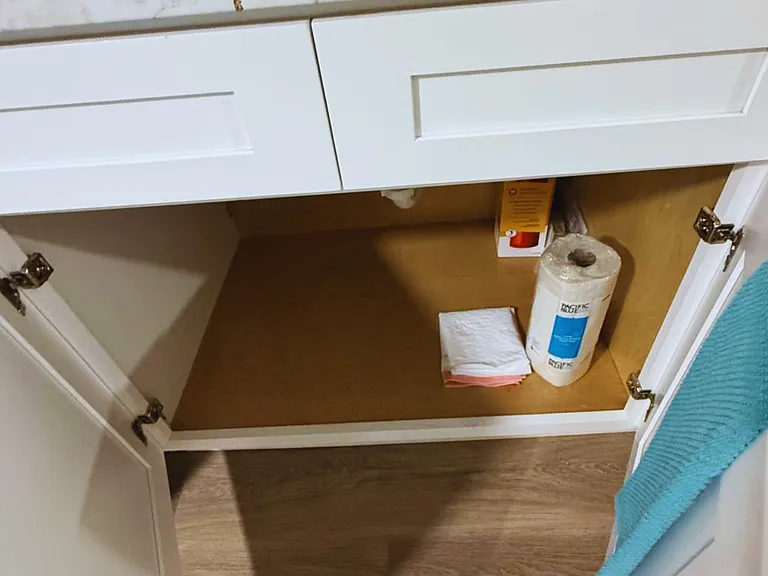 Cabinet stocked with disposable hand towels and convenience essentials.